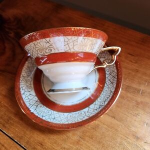 Vintage Enesco Tea Cup and Saucer Glazed Orange with Gold Trim